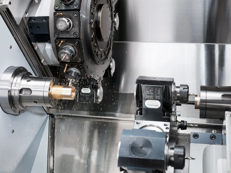 GenTurn 78-TTMY work area — twin turrets machining a part with live tooling