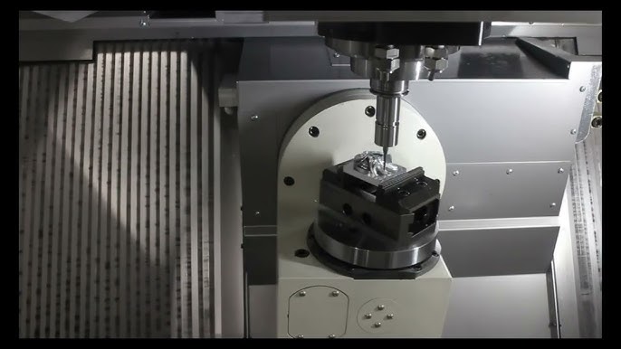 PM320-5X-T 5-axis head machining a clamped part on the trunnion table