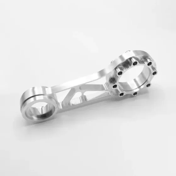 Link arm milled on a Spinner machining center: lightening pockets, webs and a drilled bolt circle