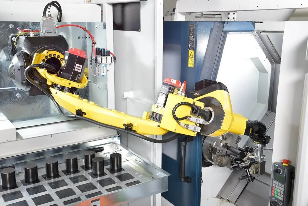 Spinner RoboBox automation: robot arm taking a blank from the parts drawer and loading it into the lathe chuck