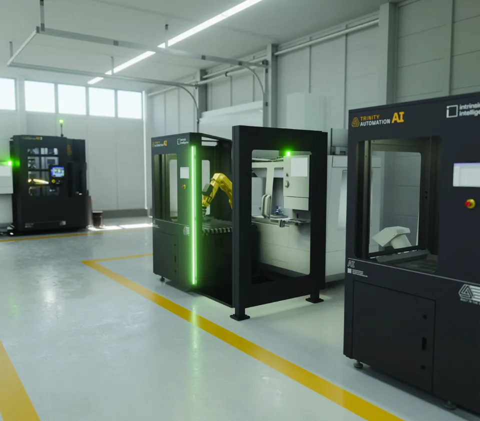 Trinity AI machine tending systems beside CNC machining centers